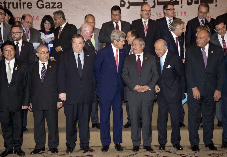 U.S. Secretary of State John Kerry, front and center, talks with Jordanian Foreign Minister Nasser Judeh, to his right, as they gather for a group photo with other Gaza Donor Conference attendees in Cairo, Egypt, Sunday, Oct. 12, 2014.  Kerry announced immediate U.S. assistance of $212 million as the conference began. Qatar has pledged $1 billion and the United Arab Emirates pledged $200 million toward reconstruction of Gaza Strip after a 50-day Israel-Hamas war. Palestinian President Mahmoud Abbas has said Gaza needs $4 billion. (AP Photo/Carolyn Kaster, Pool)