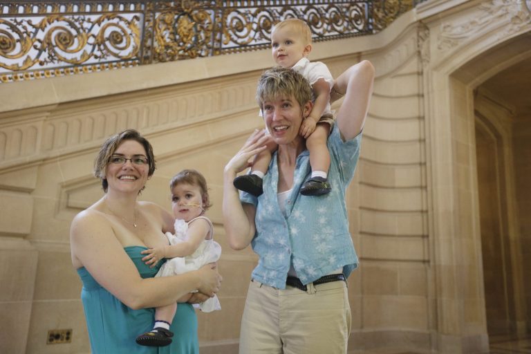 Kim, at right, and Rachel Hadley exchange wedding vows as they hold their twins Sidney, center left, and Phin at City Hall in San Francisco, Saturday,  June 29, 
2013. (AP Photo/Marcio Jose Sanchez)