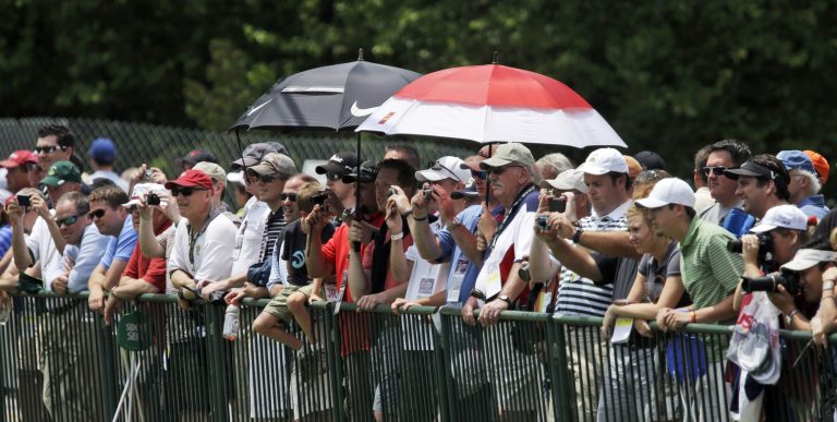 Gene J. Puskar/AP
Spectators try to take cover from rainy conditions as they watch U.S. Open practice rounds at Merion Golf Club in Ardmore, Pa., on Tuesday.