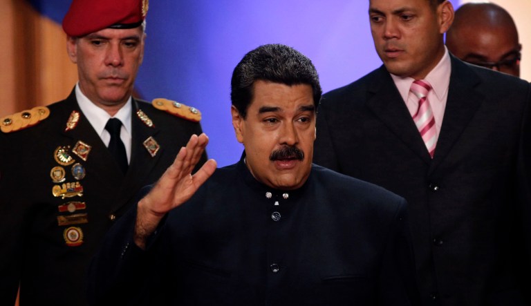 Venezuela's President Nicolas Maduro, center, arrives for a news conference in Caracas, Venezuela, Tuesday, Aug. 22, 2017. (AP Photo/Ariana Cubillos)