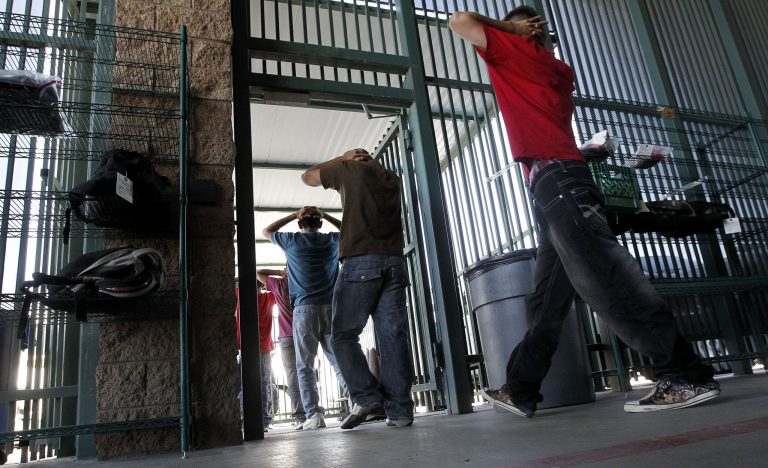 In this Aug. 9, 2012 file photo, people attempting to immigrate illegally are initially processed at Tucson Sector U.S. Border Patrol Headquarters in Tucson, Ariz. (AP Photo/Ross D. Franklin, File)