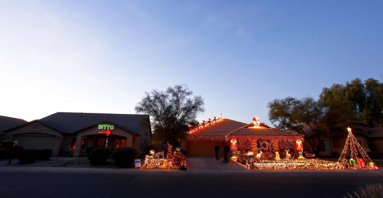   Unable to compete with her neighbor, Eric Cyr, Kristina Green opted to decorate her home, left, with a 450-light 