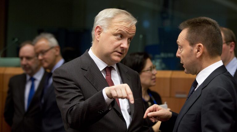 European Commissioner for Economic Affairs Olli Rehn, left, speaks with Greek Finance Minister Yannis Stournaras during a meeting of eurogroup finance ministers at the European Council building in Brussels on Monday, Jan. 27, 2014. Eurozone finance ministers on Monday were to discuss Greece's economic issues and the frustrating pace of negotiations. (AP Photo/Virginia Mayo)