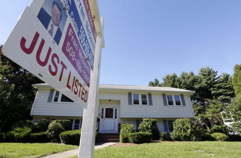   In this Wednesday, Sept. 18, 2013 photo a for sale sign hangs in front of a house in Walpole, Mass. U.S. home sales rose in August 2013 to the highest level since February 2007 as buyers rushed to close deals before interest rates rise further.( AP Photo/Steven Senne)  