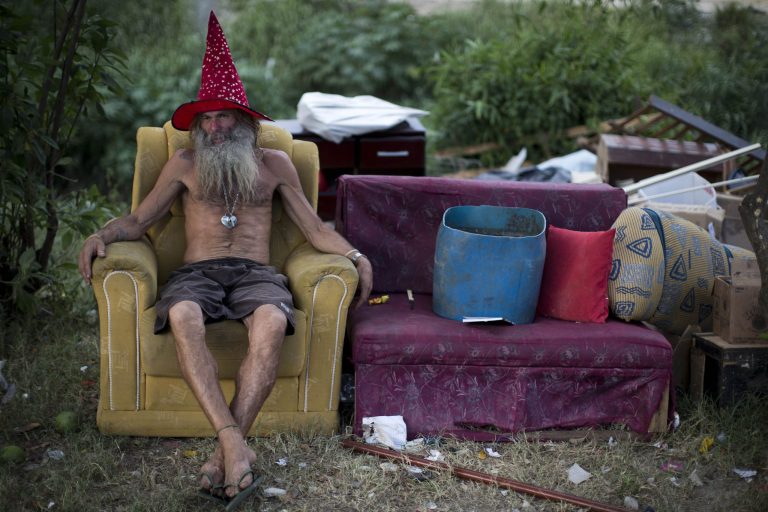   In this photo taken Dec. 21, 2012, former soldier Bobo sits on an armchair after collecting recyclables at a slum in Rio de Janeiro, Brazil. Bobo spends his day sorting through trash for recyclables to sell. At night, he turns the day's profit into crack. With a boom in crack use over the past decade, Brazilian authorities are struggling to help such users and stop the drug's spread, sparking a debate over the legality and efficiency of forcibly interning users. (AP Photo/Felipe Dana)  