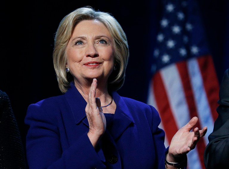 Democratic presidential candidate Hillary Clinton stands on stage at the Battle Born Battleground First in the West Caucus Dinner, Wednesday, Jan. 6, 2016, in Las Vegas. (AP Photo/John Locher)