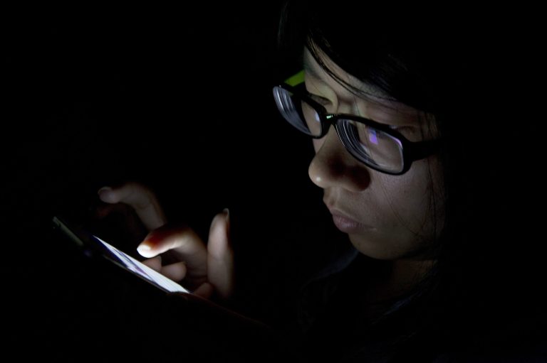 FILE - In this Sept. 11, 2013 file photo, a journalist uses her mobile device during a media event held in Beijing. Beyond setting up passcodes, some phones have additional tools for hiding or securing sensitive photos and documents. (AP Photo/Ng Han Guan, File)