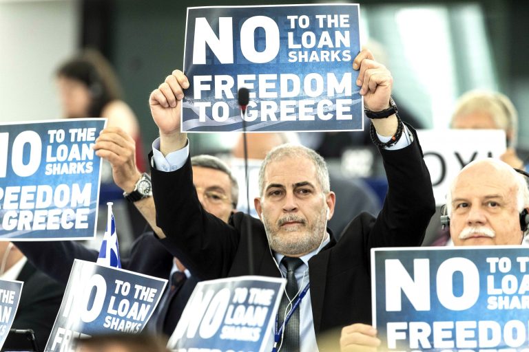 Far-right E.U Parliament members display posters before Greek Prime Minister Alexis Tsipras delivers his speech at the European Parliament in Strasbourg, eastern France, Wednesday, July 8, 2015. (AP Photo/Jean-Francois Badias)