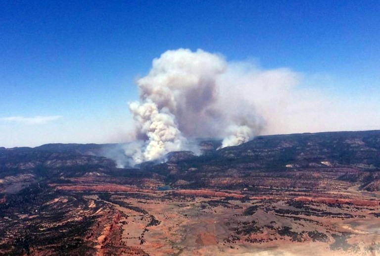 This image provided by Inci Web shows a plume of smoke in the Chuska Mountains near Naschitti, N.M. on Sunday, June 15, 2014.  Residents of a Navajo community near the New Mexico-Arizona border prepared for evacuations Monday as strong winds fanned the flames of a wildfire burning in the Chuska Mountains.  Fire officials were conducting reconnaissance missions to get a better handle on the fire's size, but Navajo Nation officials said more than 3 square miles have been charred since the fire was first reported Friday. (AP Photo/Inciweb)