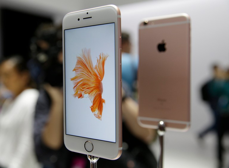 In this Sept. 9, 2015 photo, people look over the new Apple iPhone 6s models during a product display following an Apple event in San Francisco. (AP Photo/Eric Risberg)