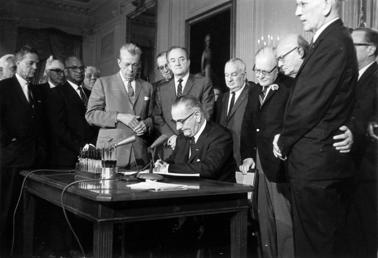 FILE - This July 2, 1964 file photo shows President Lyndon Baines Johnson signing the Civil Rights Act in the East Room of the White House in Washington. Standing, from left, are Sen. Everett Dirksen, R-Ill.; Rep. Clarence Brown, R-Ohio; Sen. Hubert Humphrey, D-Minn.; Rep. Charles Halleck, R-Ind.; Rep. William McCullough, R-Ohio; and Rep. Emanuel Celler, D-N.Y. The Civil Rights Act of 1964 is considered one of the most celebrated legislative achievements in U.S. history. Signed on July 2, 1964 by President Lyndon B. Johnson, this law made it illegal to discriminate on the basis of race, color, religion, sex, or national origin, and barred unequal application of voter registration requirements. (AP Photo, File)