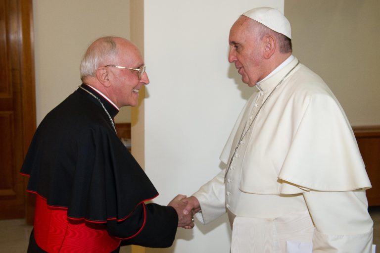 In this photo taken on Sunday, Aug. 10, 2014 provided by the Vatican paper L'Osservatore Romano, Pope Francis shakes hands with Cardinal Fernando Filoni at the Vatican. Pope Francis is sending Cardinal Filoni as his personal envoy to Iraq to show solidarity with Christians who have been forced from their homes by Islamic militants. (AP Photo/L'Osservatore Romano)