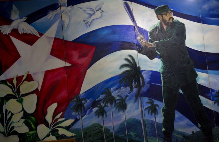 A mural of Fidel Castro playing baseball decorates a wall at the Latin American baseball stadium in Havana, Cuba. (AP Photo/Ramon Espinosa)