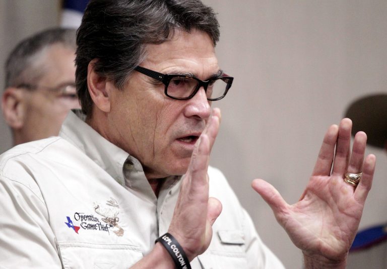 Texas Gov. Rick Perry talks to the media Monday, June 23, 2014, in Weslaco, Texas, after touring the McAllen Border Patrol station. (AP Photo/The Monitor, Gabe Hernandez)