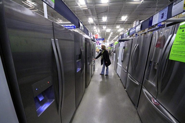 In this Thursday, Jan. 16, 2014, photo,  a woman walks through a display of refrigerators at a Lowe's store in Cranberry Township, Pa.  The Commerce Department releases durable goods for January on Thursday, Feb. 27, 2014. (AP Photo/Gene J. Puskar)