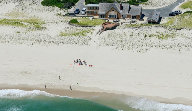 In this Sunday, July 2, 2017, photo, New Jersey Gov. Chris Christie uses the beach with his family and friends at the governor's summer house at Island Beach State Park in New Jersey. (Andrew Mills/NJ Advance Media via AP)