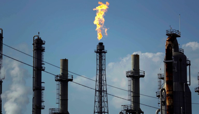 In this 2017 photo, a flame burns at the Shell Deer Park oil refinery in Deer Park, Texas. The last time Americans received tax cuts, the benefits were wiped out by oil price spikes. But the Trump administration has an opportunity, with its recent passage of the Tax Cut and Jobs Act, to avoid these past mistakes. (AP Photo/Gregory Bull, File)