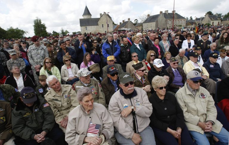 U.S WWII veterans, foreground, some of them who landed on Picauville France on June 6, 1944 , attend with locals a ceremony as part of the commemoration of the 70th D-Day anniversary, Thursday. World leaders and veterans prepare to mark the 70th anniversary of the D-Day invasion this week in Normandy. (AP Photo/Claude Paris)