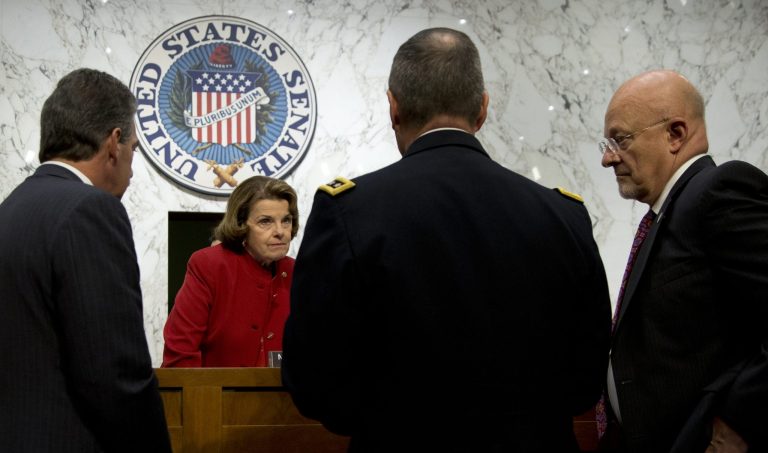   Senate Intelligence Committee ChairmaSen. Dianne Feinstein, D-Calif., second from left, talks with from left, Deputy Attorney General James Cole, National Security Agency Director General Keith Alexander, and Director of National Intelligence James Clapper, on Capitol Hill in Washington, Thursday, Sept. 26, 2013, before the start of the committee's hearing on the Foreign Intelligence Surveillance Act (FISA), and National Security Agency (NSA) call records. Lawmakers who oversee US intelligence agencies are working to expand the government's spying powers to allow the FBI to immediately begin electronically monitoring terror suspects who travel to the United States and who already were under surveillance overseas by the NSA. (AP Photo/Carolyn Kaster)  