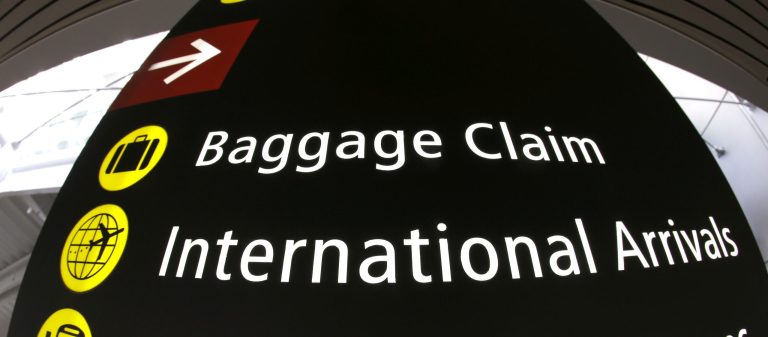 A sign for International Arrivals is shown at the Seattle-Tacoma International Airport, Monday, June 26, 2017, in Seattle. (AP Photo/Ted S. Warren)