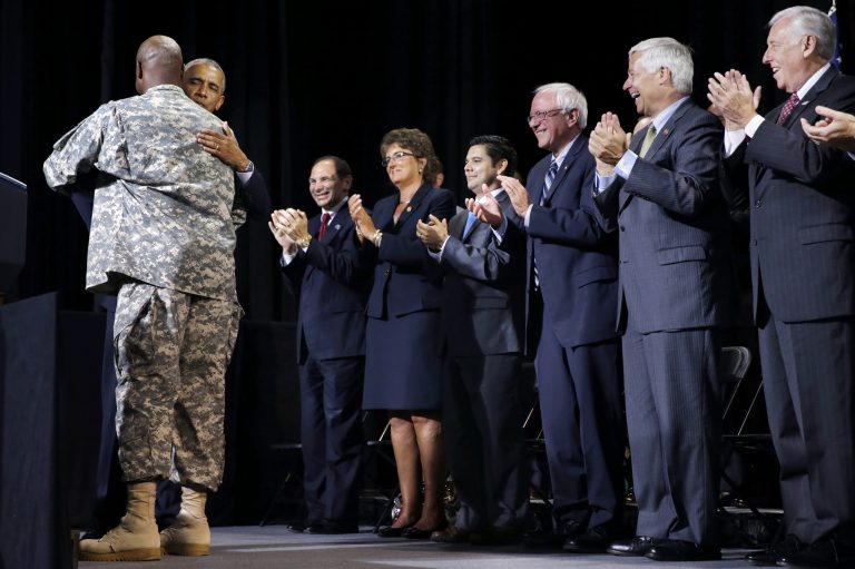 President Barack Obama hugs Stg. Maj. James McGruder as he arrives to speak at the Wallace Theater in Fort Belvoir, Va., Thursday, Aug. 7, 2014, about H.R. 3230, the Veterans' Access to Care through Choice, Accountability, and Transparency Act of 2014. (AP Photo/Jacquelyn Martin)