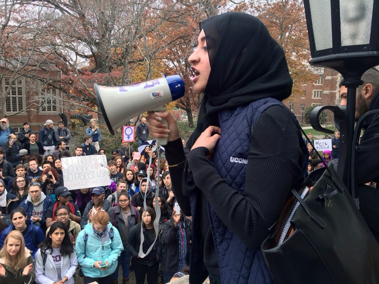 In this Wednesday, Nov. 9, 2016 file photo, Eeman Abbasi speaks during a protest on the University of Connecticut campus against the election of Republican Donald Trump as president in Storrs, Conn. Abbasi, a junior psychology and neurobiology major, said as a Muslim student she feels that the American people told her Tuesday night that even though she was born in this country she doesn't belong here. (AP Photo/Pat Eaton-Robb)