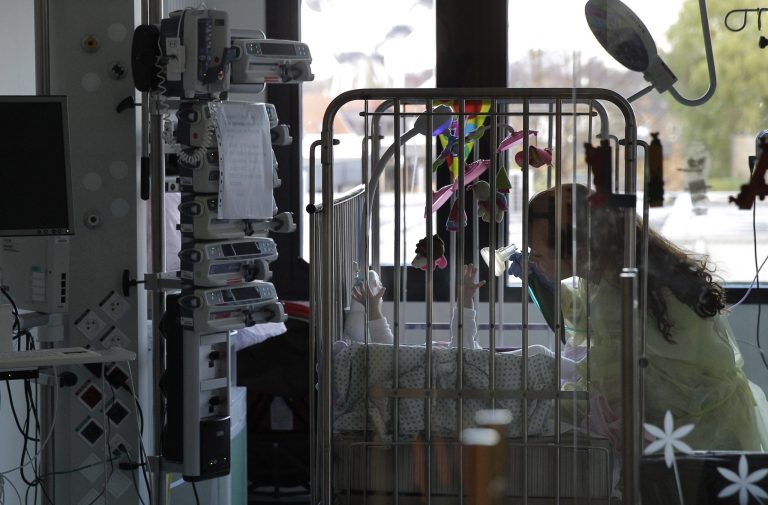 A nurse helps a baby with a respiratory mask, at the intensive care unit of the Queen Fabiola Children's Hospital in Brussels, Monday, Nov. 25, 2013. (AP File)