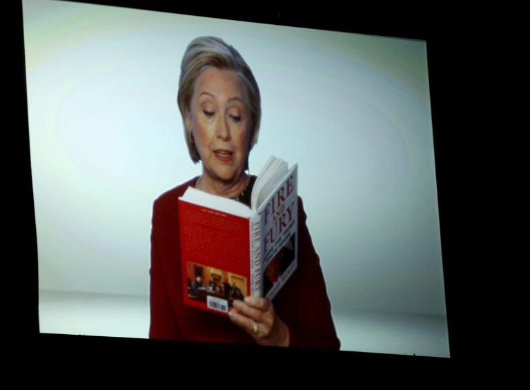 Hillary Clinton appears on screen reading an excerpt from the book 