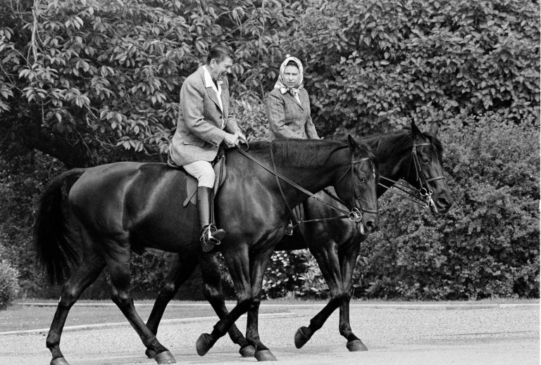   FILE - In this June 8, 1982 file photo, U.S. President Ronald Reagan, on Centennial, and Britain's Queen Elizabeth II, on Burmese, go horseback riding on the grounds of Windsor Castle, England. It is not often that the president of the United States needs to seek fashion advice. But when Ronald Reagan was getting ready for a visit to England as a guest of Queen Elizabeth II in June 1982, his people had an important question for the Brits: Just what does one wear to go riding with the queen in the magnificent horse country surrounding Windsor Castle? The answer: Something smart, but casual, of course. Riding boots, breeches and a turtleneck sweater would do fine _ no need for formal riding attire. The fashion inquiry is but one tidbit contained in nearly 500 pages of formerly Confidential documents relating to the Reagan visit being made public Friday, Dec. 28, 2012 by Britainâs National Archives. (AP Photo/Bob Daugherty, File)  