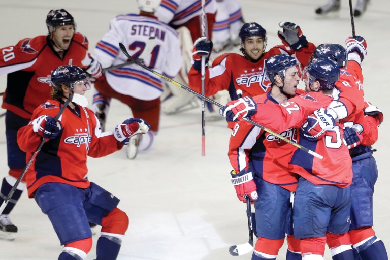 Evan Vucci/AP
An overtime goal by Mike Green, right, in Game 2 gave the Capitals a 2-0 edge in their playoff series with the Rangers.
