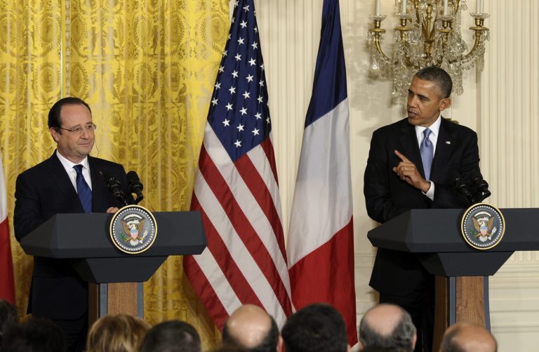 President Barack Obama gestures toward French President FranÃ§ois Hollande during their joint news conference, as part of an official state visit, Tuesday, Feb. 11, 2014, in the East Room of the White House in Washington. Lauding the 