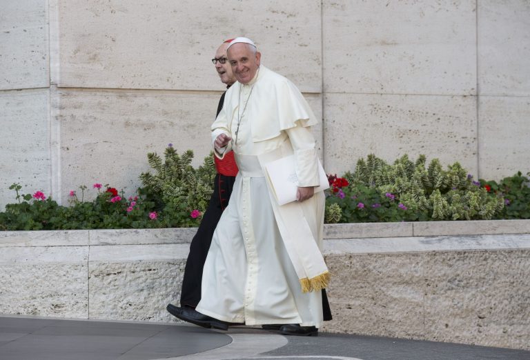 Pope Francis, flanked by Cardinal Fernando Sebastian Aguilar, arrives at a morning session of a two-week synod on family issues at the Vatican, Tuesday, Oct. 7, 2014. Francis has urged bishops to speak their minds about contentious issues like contraception, gays, marriage and divorce at the start of the meeting aimed at making the church's teaching on family matters relevant to today's Catholics. (AP Photo/Alessandra Tarantino)