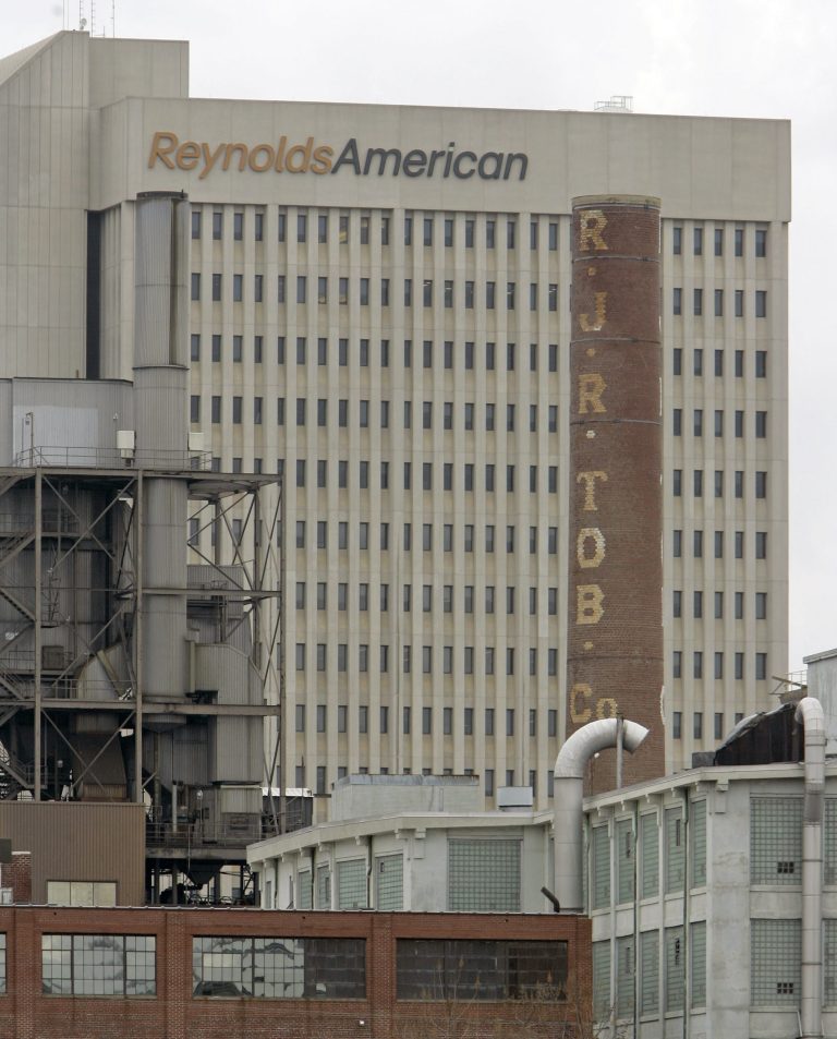 In this Feb. 6, 2008 photo, a smokestack of an old R.J. Reynolds Tobacco plant frames the Reynolds American building in Winston-Salem, N.C., A Florida jury has slammed R.J. Reynolds Tobacco Co. with $23.6 billion in punitive damages in a lawsuit filed by Cynthia Robinson, the widow of a longtime smoker who died of lung cancer in 1996.  The damages the jury awarded to Robinson on Friday, July 18, 2014, after a four-week trial come in addition to $16.8 million in compensatory damages.  (AP Photo/Chuck Burton)