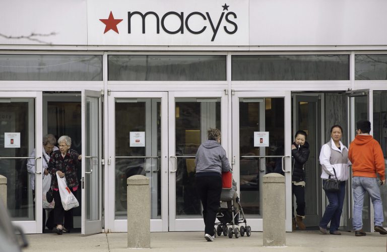 FILE - In this April 29, 2014 file photo, shoppers enter and leave a Macy's department store in Braintree, Mass. Macy's Inc. reports quarterly financial results before the market opens Wednesday, Aug. 13, 2014. (AP Photo/Stephan Savoia)