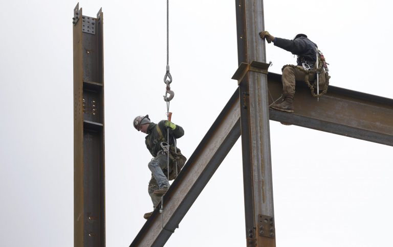 In this Tuesday, April 29. 2014 photo, workers position iron girders at a building construction site, in Boston. The Commerce Department reports on U.S. construction spending in March on Thursday, May 1, 2014. (AP Photo/Steven Senne)