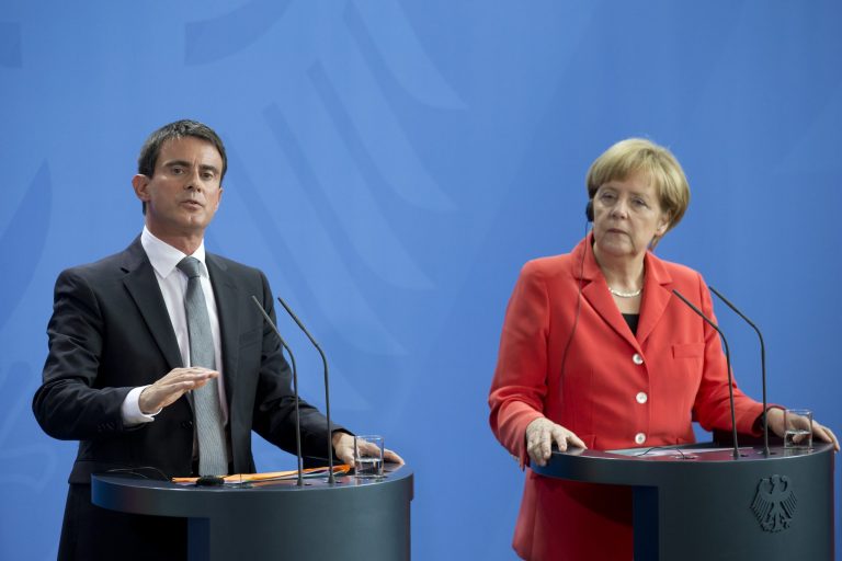 German Chancellor Angela Merkel, right, and the Prime Minister of France, Manuel Valls, left, attend a press conference following their meeting at the chancellery in Berlin, Germany, Monday, Sept. 22, 2014. (AP Photo/Axel Schmidt)