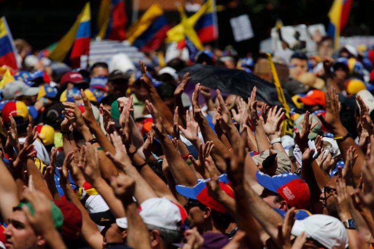 Supporters hold out their hands to greet Carlos Vecchio, the national political coordinator of the Popular Will party, an anti-government group formed by jailed opposition leader Leopoldo Lopez before his arrest,  during an anti-government protest in Caracas, Venezuela, Saturday, March 22, 2014. Vecchio addressed the crowd in defiance of an arrest order. Two more people were reported dead in Venezuela as a result of anti-government protests even as supporters and opponents of President Nicolas Maduro took to the streets on Saturday in new shows of force. (AP Photo/Fernando Llano)