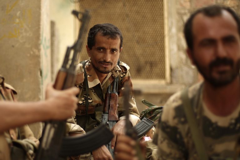   A Yemeni army soldier, center, looks on as he sits with his comrades at their post in the town of Jaar in southern Abyan province, Yemen, Friday, June 15, 2012. Yemen says government troops have killed scores of militants in a push to rout al-Qaida fighters from the last town under militant control in the southern Abyan province. (AP Photo/Hani Mohammed)  