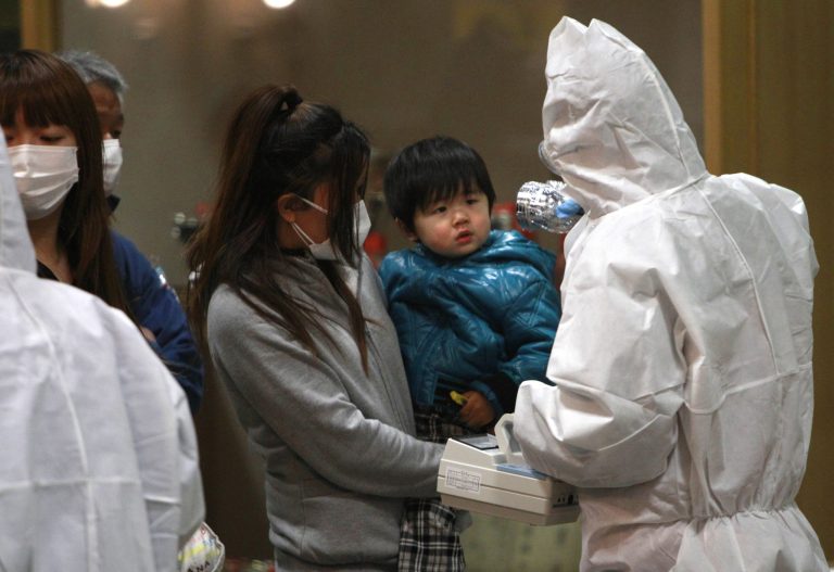   FILE - In this March 15, 2011 file photo, a child is screened for radiation exposure at a testing center in Koriyama city, Fukushima Prefecture, Japan, after a nuclear power plant on the coast of the prefecture was damaged by March 11 earthquake. Experts and the government say there have been no visible health effects from the radioactive contamination from Fukushima Dai-ichi so far. But they also warn that even low-dose radiation carries some risk of cancer and other diseases, and exposure should be avoided as much as possible, especially the intake of contaminated food and water. Such risks are several times higher for children and even higher for fetuses, and may not appear for years. Okinawa has welcomed the people from Fukushima and other northeastern prefectures (states) affected by the March 11, 2011, earthquake and tsunami that set off the nuclear disaster. (AP Photo/Wally Santana,File)  