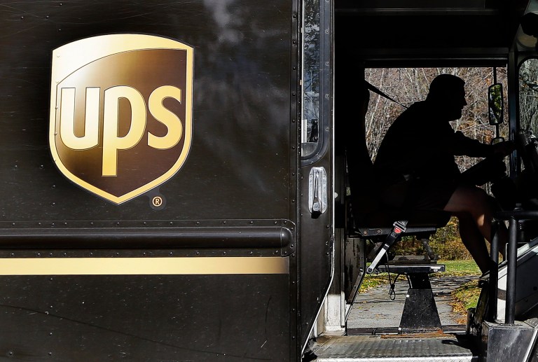 FILE - In this Monday, Oct. 22, 2012, file photo, a UPS driver drives after a delivery in North Andover, Mass. UPS reports quarterly earnings on Thursday, April 24, 2014. (AP Photo/Elise Amendola)