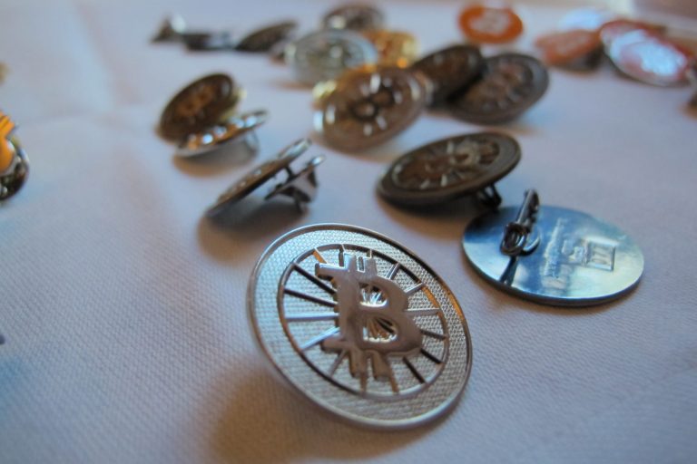 BitcoinÃÂ buttons are displayed on a table at the InsideÃÂ BitcoinsÃÂ conference in Berlin. (AP/Frank Jordans)