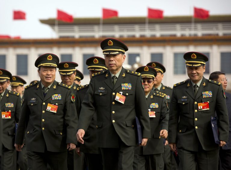Military officials arrive at the Great Hall of the People in Beijing, Sunday, March 8, 2015. (AP Photo/Mark Schiefelbein)
