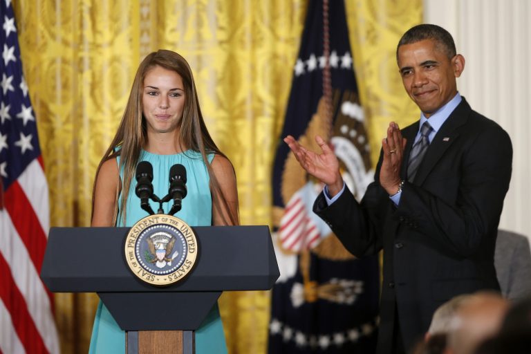 President Barack Obama applauds Victoria Bellucci, a 2014 graduate of Huntingtown High Shool in Huntingtown, Md., who suffered five concussions playing soccer, Thursday, May 29, 2014, in the East Room of the White House in Washington, during the White House Healthy Kids and Safe Sports Concussion Summit. Obama was hosting a summit with representatives of professional sports leagues, coaches, parents, young athletes, researchers and others to call attention to the issue of youth sports concussions. (AP Photo/Charles Dharapak)