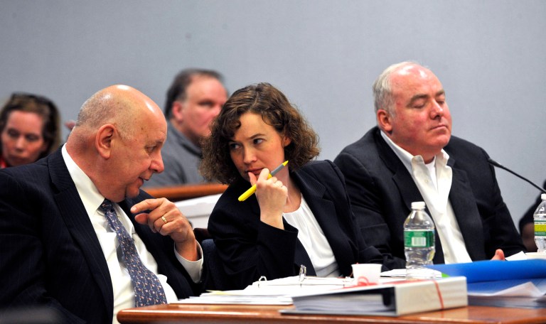 Defense attorneys Hubert Santos, left, and Jessica Santos speak to one another as Michael Skakel looks on during the second day of Skakel's appeal trial at Rockville Superior Court on Wednesday, April 17, 2013 in Rockville, Conn. Attorney's for Skakel accused Michael Sherman, the attorney who represented him at his murder trial of having a good time making trips around the country instead of preparing for the case. Skakel is the 52-year-old nephew of Robert F. Kennedy's widow, Ethel. He's serving 20 years to life in prison for the 1975 golf club bludgeoning of Greenwich neighbor Martha Moxley when they were both 15. (AP Photo/The Stamford Advocate, Jason Rearick, Pool)