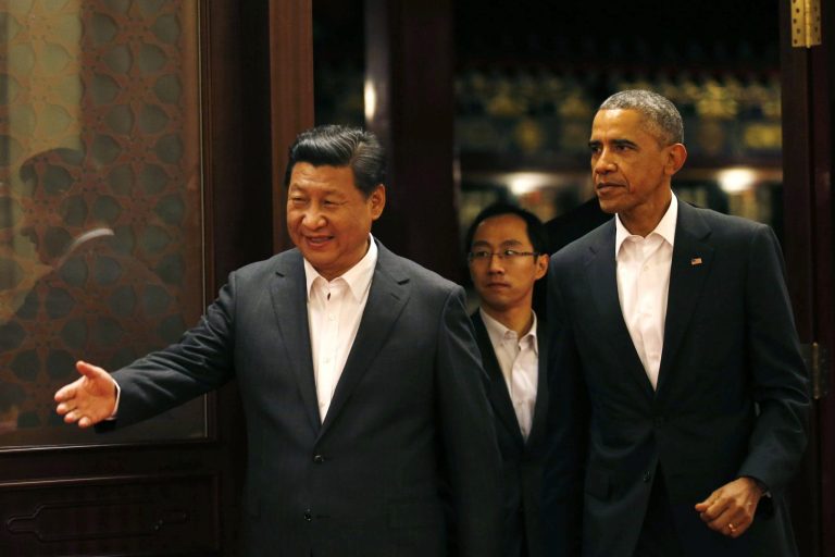 U.S. President Obama, right, is shown the way by China's President Xi Jinping as they enter a room for a meeting after participating in the Asia Pacific Economic Cooperation (APEC) summit at the Zhongnanhai leadership compound in Beijing Tuesday. (AP Photo/Kim Kyung-Hoon, Pool)