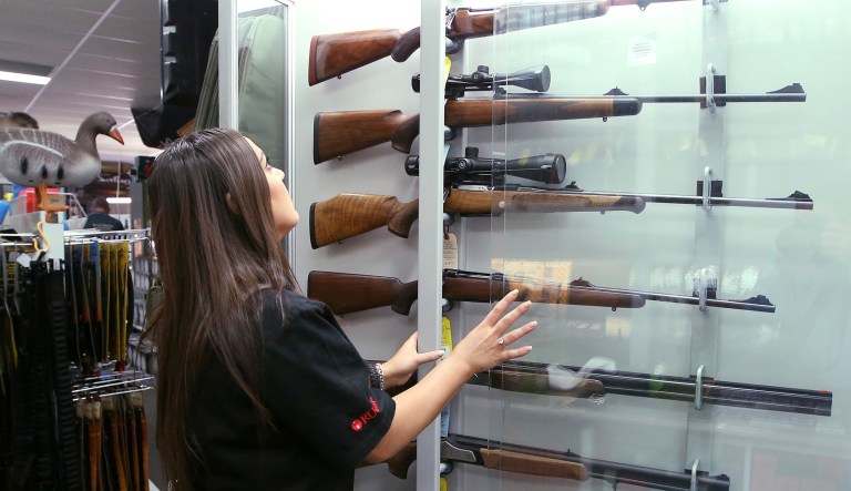 A salesperson checks rifles in a display in a gun shop in Sydney. Former Australian foreign minister said, 