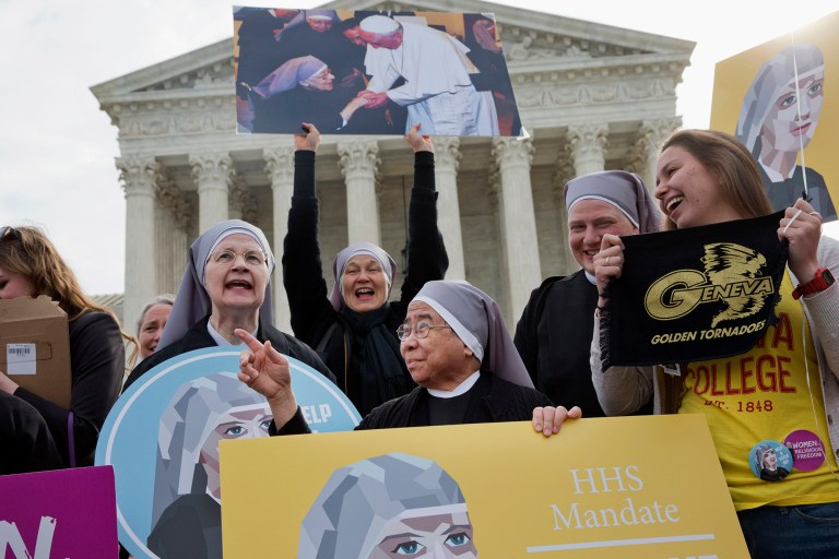 Nuns with the Little Sisters of The Poor, including Sister Celestine, left, and Sister Jeanne Veronique, center, rally outside the Supreme Court in Washington, Wednesday, March 23, 2016, as the court hears arguments to allow birth control in healthcare plans in the Zubik vs. Burwell case.