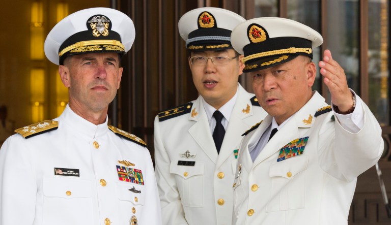 Commander of the Chinese Navy Adm. Wu Shengli, right, points out the layout of the Chinese Navy Headquarters to visiting U.S. Chief of Naval Operations Adm. John Richardson, left, in Beijing, Monday, July 18, 2016. Richardson met Wu during his trip to Beijing and the port city of Qingdao that began on Sunday. He is also scheduled to visit the navy's submarine academy, tour China's first aircraft carrier and discuss ongoing Rim of the Pacific military drills. 