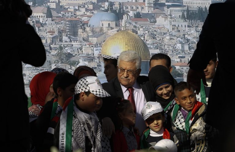   Palestinian President Mahmoud Abbas, center, is surrounded by children during celebrations for the successful bid to win U.N. statehood recognition for Palestine in the West Bank city of Ramallah, Sunday, Dec. 2, 2012. Abbas has returned home to a hero's welcome after winning a resounding endorsement for Palestinian independence at the United Nations. Israel on Sunday roundly rejected the United Nations' endorsement of an independent state of Palestine, announcing it would withhold more than $100 million collected for the Palestinian government to pay debts to Israeli companies and earlier said it would start drawing up plans to build thousands of settlement homes. (AP Photo/Nasser Shiyoukhi)  