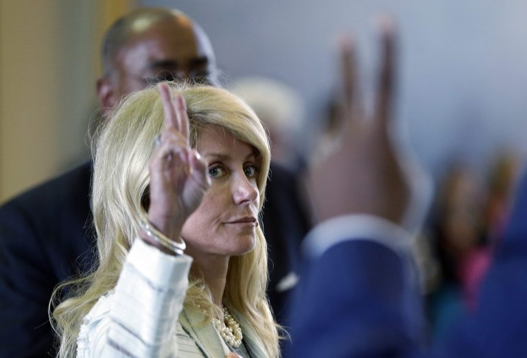 Sen. Wendy Davis, D-Fort Worth, left, votes against a motion to call for a rules violation during her filibusters of an abortion bill, Tuesday, June 25, in Austin, Texas. (AP Photo/Eric Gay)